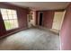Outdated pink bedroom with visible closet and en-suite bathroom access at 13026 Baltimore Woods Ln, Orlando, FL 32824