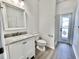 Bathroom featuring vanity with marble countertop, toilet, and glass-enclosed shower at 9632 Spring Lake Dr, Clermont, FL 34711