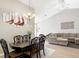 Elegant dining area featuring a dining table and a living space with a comfortable couch at 9632 Spring Lake Dr, Clermont, FL 34711