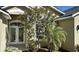 Charming front entry of home with a double door and colorful mature landscaping at 9632 Spring Lake Dr, Clermont, FL 34711