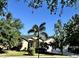 Charming single-story home surrounded by lush landscaping and mature trees, offering great curb appeal at 9632 Spring Lake Dr, Clermont, FL 34711