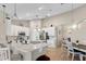 Well-appointed kitchen with white cabinets, an island, and stainless steel appliances at 9632 Spring Lake Dr, Clermont, FL 34711