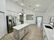 Bright open kitchen featuring stainless steel appliances and a center island with pendant lighting at 9632 Spring Lake Dr, Clermont, FL 34711