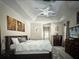 Spacious main bedroom with a tray ceiling and plush carpet, with decoratively appointed walls at 9632 Spring Lake Dr, Clermont, FL 34711