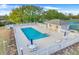 Community pool with ample seating, umbrellas, and a small pool house, perfect for relaxation at 9632 Spring Lake Dr, Clermont, FL 34711