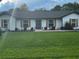 Lovely home featuring a meticulously maintained green lawn, white exterior, and classic shutters at 1114 Dove Ln, Winter Springs, FL 32708
