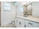 Stylish bathroom with granite counters, tiled floors, and a bright window at 508 Bacio St, New Smyrna Beach, FL 32168