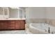 Bathroom with double sinks and a soaking tub at 508 Bacio St, New Smyrna Beach, FL 32168