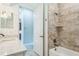 Updated bathroom with a shower and granite counters and neutral tiling at 508 Bacio St, New Smyrna Beach, FL 32168