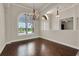 Bright dining room boasts wood floors, arched windows, elegant lighting and neutral paint scheme at 508 Bacio St, New Smyrna Beach, FL 32168