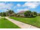 Well-maintained single-story home with lush green grass, a tidy landscaped flowerbed, and a concrete sidewalk at 508 Bacio St, New Smyrna Beach, FL 32168
