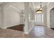 Bright and spacious foyer with tile flooring, arched entryways, and views into adjacent rooms featuring hardwood floors at 508 Bacio St, New Smyrna Beach, FL 32168