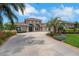 Beautiful single-story home with a manicured lawn, colorful landscaping, and a spacious driveway leading to the front entrance at 508 Bacio St, New Smyrna Beach, FL 32168