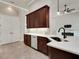 A kitchen showcases dark cabinets, white countertops, and stainless steel appliances with tile flooring at 508 Bacio St, New Smyrna Beach, FL 32168