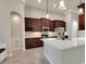 A modern kitchen features dark cabinets, stainless steel appliances, and a stylish white countertop island at 508 Bacio St, New Smyrna Beach, FL 32168