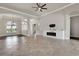 Open-plan living room features tile flooring, fireplace, recessed lighting, and views to dining room at 508 Bacio St, New Smyrna Beach, FL 32168