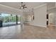 Spacious open floor plan from the living room with view into kitchen and sliding glass doors to the pool at 508 Bacio St, New Smyrna Beach, FL 32168