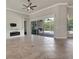 Bright living room has large sliding glass doors to the screened in patio and pool at 508 Bacio St, New Smyrna Beach, FL 32168