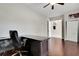 Office space featuring wood flooring, large desk, neutral paint scheme, ceiling fan, and closet at 508 Bacio St, New Smyrna Beach, FL 32168