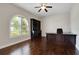 Inviting office with built in bookcase, large wooden desk, ceiling fan, and wood flooring at 508 Bacio St, New Smyrna Beach, FL 32168