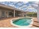 The screened-in patio features a swimming pool, brick decking, outdoor kitchen and ceiling fans at 508 Bacio St, New Smyrna Beach, FL 32168