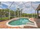 Screened-in pool area features lush landscaping to add a touch of nature, as well as a brick deck at 508 Bacio St, New Smyrna Beach, FL 32168