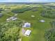 Expansive aerial view of estate featuring open fields, ponds and multiple outbuildings at 11657 Moore Rd, Lakeland, FL 33809
