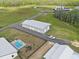 Aerial view of the property featuring the house, outbuilding, pool, and playground at 11657 Moore Rd, Lakeland, FL 33809