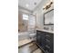 Cozy bathroom features a tub with shower, tiled floors and a modern vanity at 11657 Moore Rd, Lakeland, FL 33809