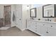 Bright bathroom features double vanity with marble counters, tiled floors, and walk in shower at 11657 Moore Rd, Lakeland, FL 33809