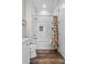 Bright bathroom features white cabinets, a tub with white subway tile, and wood-look flooring at 11657 Moore Rd, Lakeland, FL 33809