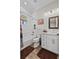 Bathroom features a tub with white subway tile, wood-look flooring, and a framed vanity mirror at 11657 Moore Rd, Lakeland, FL 33809