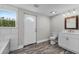 Modern bathroom featuring stylish wood-look flooring, a window, and a sleek vanity at 11657 Moore Rd, Lakeland, FL 33809