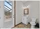Bathroom with pool access features a white vanity and toilet in a well lit area at 11657 Moore Rd, Lakeland, FL 33809