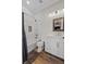Bright bathroom features white cabinets, a tub with white subway tile, and wood-look flooring at 11657 Moore Rd, Lakeland, FL 33809