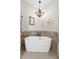 Elegant bathroom featuring a freestanding tub, chandelier, and decorative accents at 11657 Moore Rd, Lakeland, FL 33809