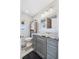Bathroom with gray vanity, granite countertop, and modern fixtures at 11657 Moore Rd, Lakeland, FL 33809