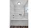 Bright bathtub featuring white tiling and a built-in niche for storage at 11657 Moore Rd, Lakeland, FL 33809