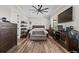 Bedroom with hardwood floors, ceiling fan, and windows overlooking the property at 11657 Moore Rd, Lakeland, FL 33809