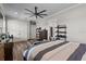 Bedroom with hardwood floors, ceiling fan and multiple windows at 11657 Moore Rd, Lakeland, FL 33809