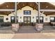 Inviting covered entryway features stone pillars, wooden beams, and double doors at 11657 Moore Rd, Lakeland, FL 33809