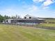 Sprawling farmhouse featuring a screened-in pool, covered patio, and large grassy yard at 11657 Moore Rd, Lakeland, FL 33809