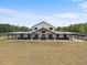 Sprawling, modern farmhouse features a long covered porch, metal roof and ample land at 11657 Moore Rd, Lakeland, FL 33809