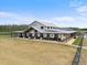 Unique farmhouse on acreage features an expansive covered porch and metal roof at 11657 Moore Rd, Lakeland, FL 33809