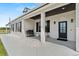 A close shot of the house's exterior, highlighting the front door, columns, dark shutters, and clean landscaping at 11657 Moore Rd, Lakeland, FL 33809