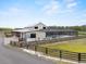 Stately farmhouse style home featuring a screened-in pool and fenced in yard at 11657 Moore Rd, Lakeland, FL 33809