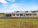 Exterior view of the house showcasing its well-maintained lawn and a convenient covered parking area at 11657 Moore Rd, Lakeland, FL 33809