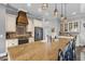 Spacious kitchen with granite countertops, custom range hood, and stainless steel appliances at 11657 Moore Rd, Lakeland, FL 33809