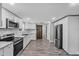 A well-lit kitchen featuring stainless steel appliances, white cabinets, and modern fixtures at 11657 Moore Rd, Lakeland, FL 33809