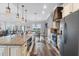 Bright, open kitchen features granite countertops, stainless steel appliances, and a farmhouse sink at 11657 Moore Rd, Lakeland, FL 33809